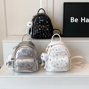 Mini floral backpacks in black silver and white with plush monster charms on steps