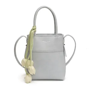 Minimalist light grey leather mini handbag for women with green tulip pendant detail