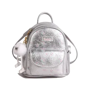 Silver metallic mini backpack with floral print and cute plush doll keychain