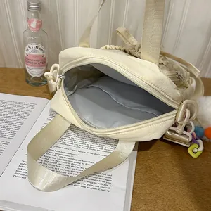Chic beige crossbody tote bag with inner pocket and colorful acrylic chain charm