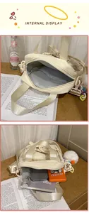 Detail showing spacious interior compartment and inner pocket of the cream crossbody bag