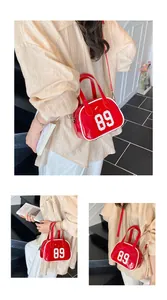 Close-up of a red patent leather bowling bag featuring a white 89 print and silver hardware