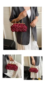 Detail of red rose evening bag with pearl accents and golden metal circular handle