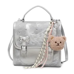 Silver metallic backpack with rhinestone bow and cute plush bear charm for fashion women