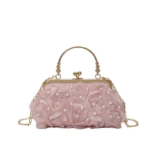 Pink evening bag with 3D chiffon roses, artificial pearls and golden metal ring handle