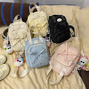 Minimalist canvas shoulder bag for women with bow detail and plush charm in five colors