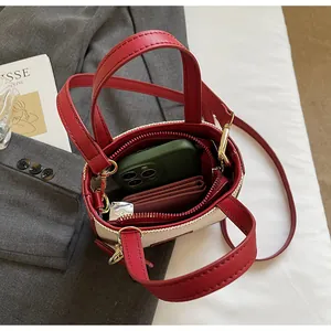 Top view of red and cream denim bag interior showing phone and wallet storage