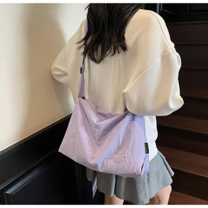Detail of light purple nylon crossbody bag with BNT embroidery on adjustable strap