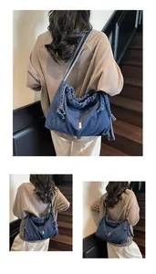 Detail of vintage denim tote bag with drawstring closure and soft texture fabric