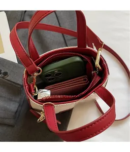 Top view of denim bag interior showing space for phone, wallet and red lining