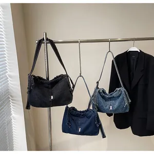 Detailed view of three vintage denim tote bags with drawstring closure in multiple washes