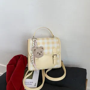 Mini yellow plaid backpack for women with bear charm and adjustable shoulder straps