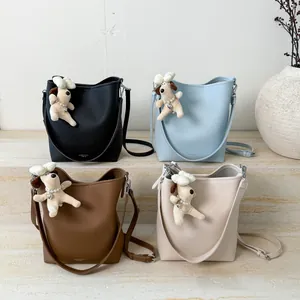 Fashionable bucket bag for women in four colors with cute plush dog charm and strap