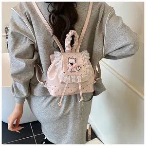 Detail of pink mini backpack with lace trim, polka dots, and cute puppy patch applique