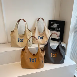 Minimalist canvas tote bag with TCT embroidery and leather handles in four chic colors