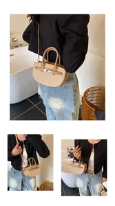 Detailed view of beige saddle bag with sequins, metal turn-lock and leather straps