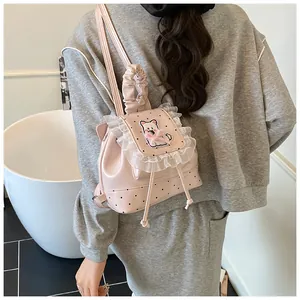 Detail of pink PU leather backpack with cat embroidery, lace trim and polka dot pattern