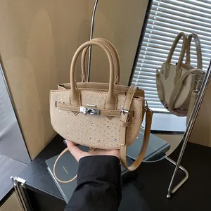 Minimalist beige woven saddle bag with sparkling rhinestone accents and leather handle