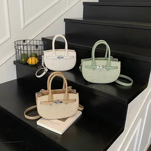 Three minimalist saddle handbags in white green and khaki with rhinestone weave details