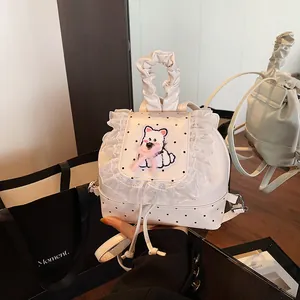 Chic white polka dot backpack featuring lace trim and a cute puppy embroidery patch