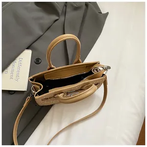 Minimalist khaki saddle handbag with rhinestone details and adjustable shoulder strap