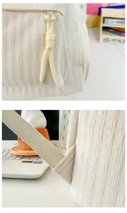 Gros plan du sac à dos blanc cassé avec texture plissée et détail de fermeture en corde
