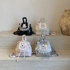 Polka dot mini backpacks in black, white, pink, and silver with lace dog embroidery