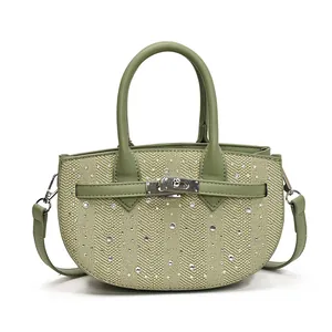 Elegant green woven saddle handbag with rhinestones and silver metallic twist lock