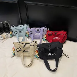 Minimalist canvas crossbody dumpling bags in five colors with cute doll pendants