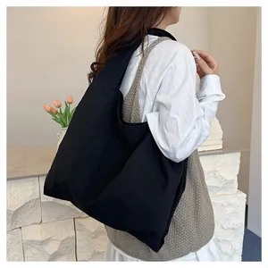 Detail view of the large capacity black canvas tote bag showing the textured fabric surface