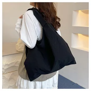 Detailed back view of a oversized black canvas tote bag on model for casual daily use