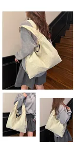 Detailed macro view showing the unique crinkled texture of this beige canvas tote bag