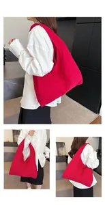 Detail view of large red canvas hobo tote bag for women showing spacious capacity and style