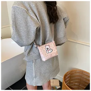 Pink polka dot crossbody bag with ruffle trim and puppy detail on model