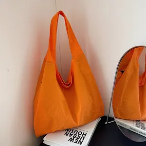 Minimalist bright orange oversized canvas tote bag in a casual Korean style for daily commuting