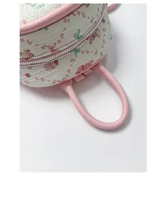 Detail of white quilted fabric with sweet cartoon patterns and pink leather handles