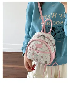 Detail of pink strawberry and bear printed mini backpack with adjustable straps on model