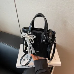 Chic black vertical stripe bucket bag with pearl lace pendant and adjustable strap
