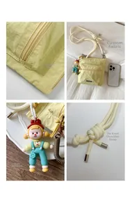 Detail views of light yellow nylon bucket bag with smooth zipper and knot strap