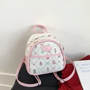 Quilted mini backpack in cream and pink with cute cartoon bear and strawberry prints