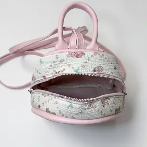 Mini pink and white quilted backpack with cute bunny floral prints and top handle