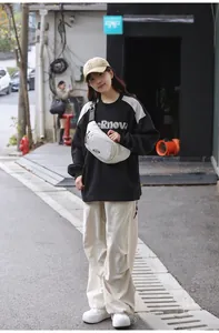 Outdoor street style view of a white nylon crossbody chest bag styled with casual streetwear