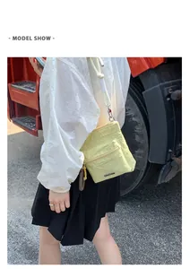 Pale yellow nylon crossbody bag detail with front zipper and chic rope shoulder strap