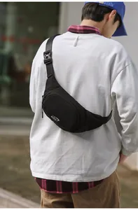 Detailed view of black nylon crossbody bag featuring an SLE logo and adjustable strap