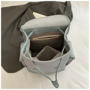 Minimalist light blue backpack with contrast striped lining and drawstring closure