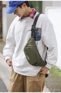 Detail of army green nylon chest bag featuring adjustable wide strap and plastic buckle