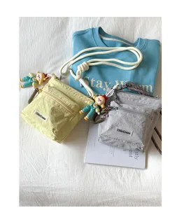 Close-up of nylon bucket bags with zippered pockets and adjustable cord straps