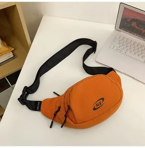Detailed top view of a bright orange nylon crossbody sports bag with black SLE logo