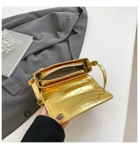 Internal structure of a gold croc-embossed crossbody bag with zipper compartment