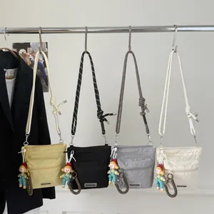 Waterproof nylon bucket bags with rope straps and cute doll charms in four colors